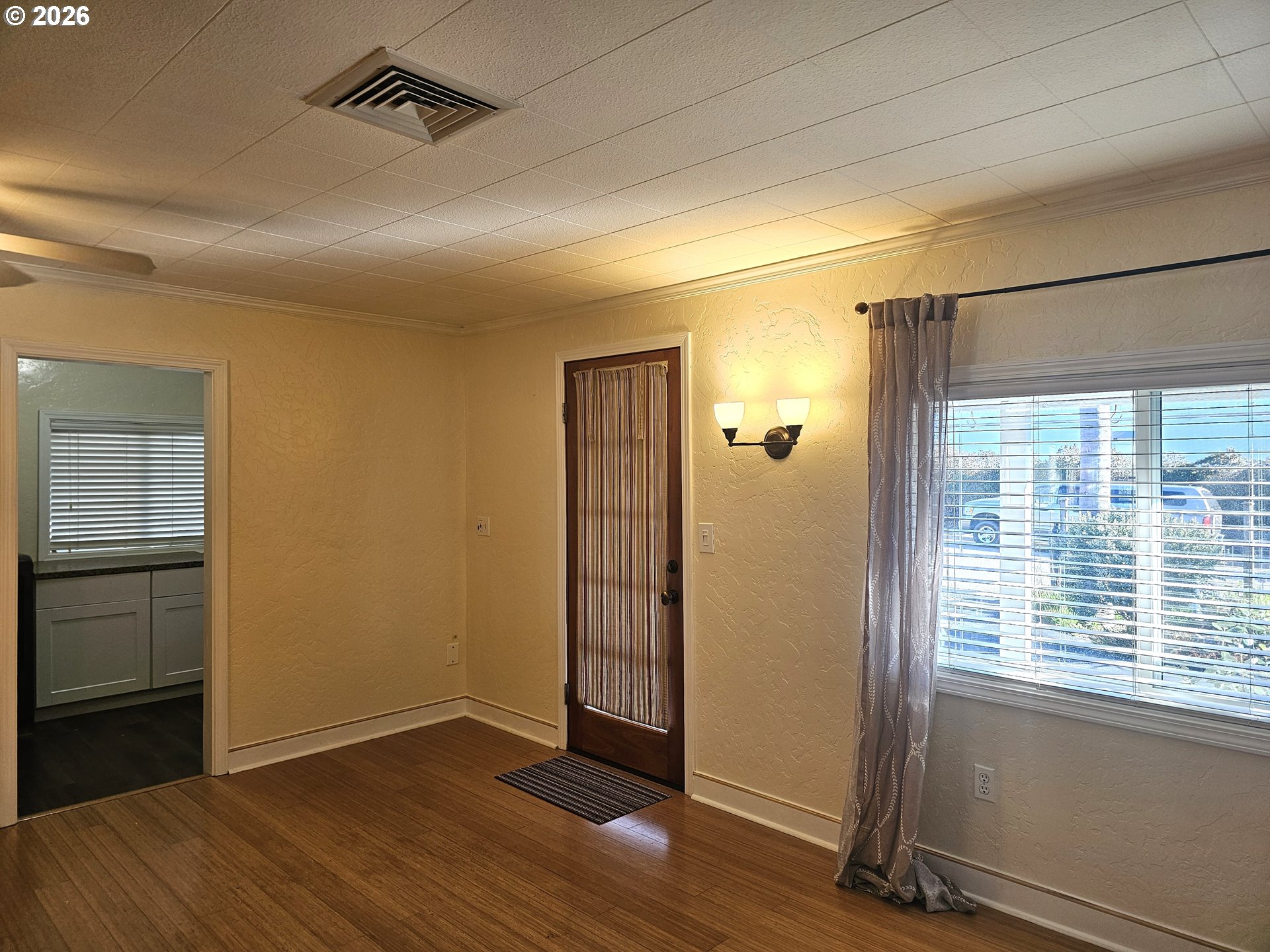 237 Wharf Street Brookings, OR 97415 - Photo 3 of 27 a view of an empty room with wooden floor and a window