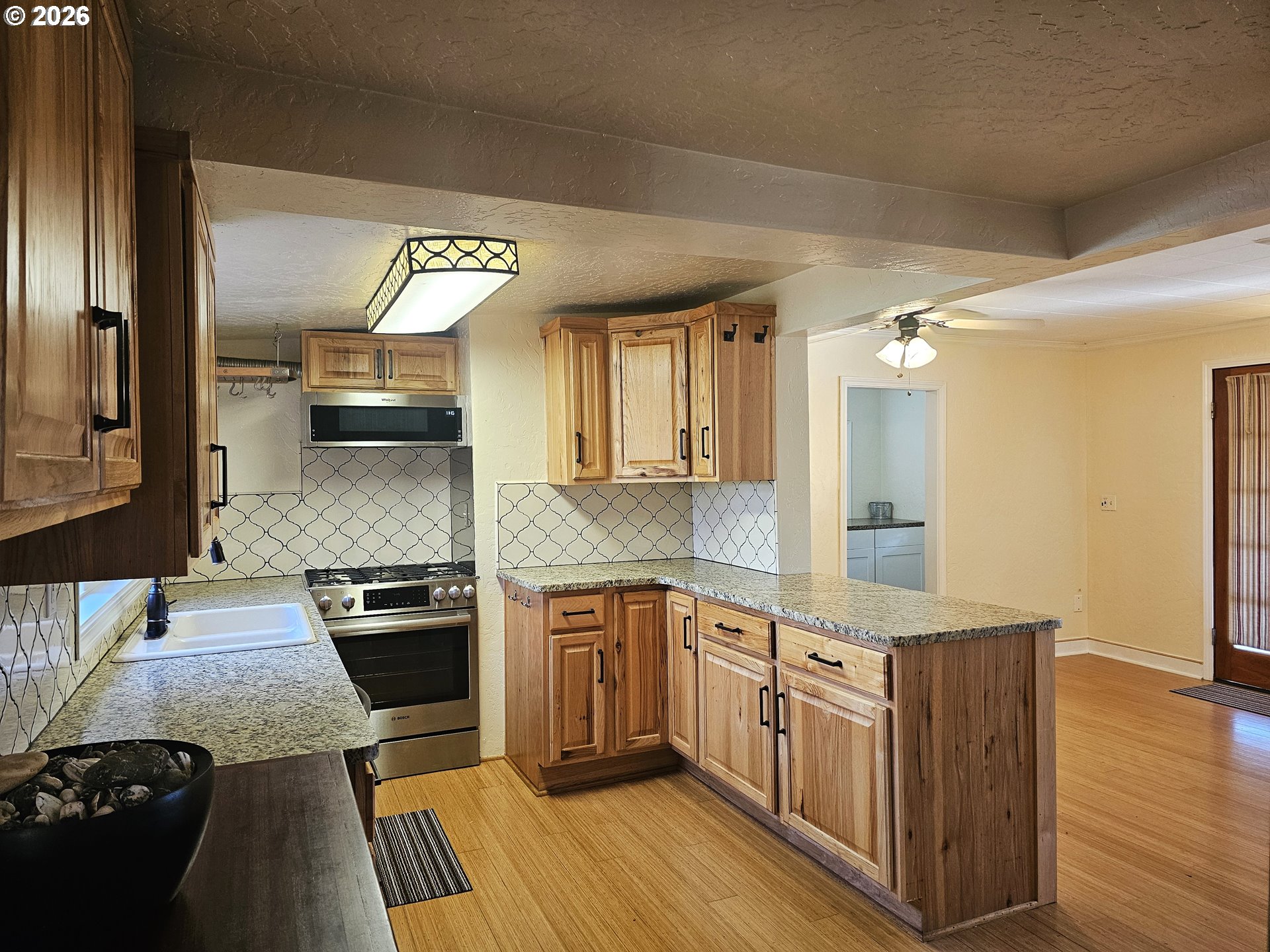 237 Wharf Street Brookings, OR 97415 - Photo 5 of 27 a kitchen with stainless steel appliances granite countertop a sink stove and refrigerator