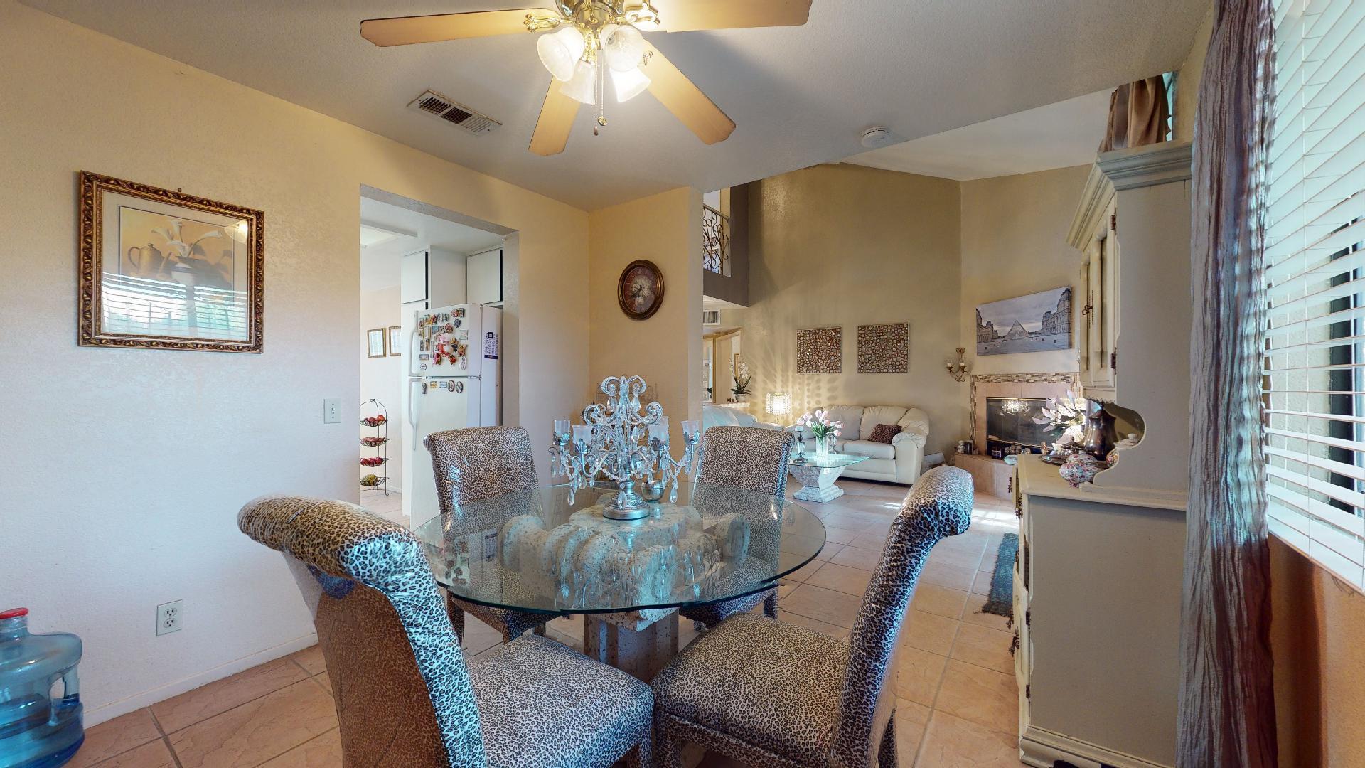 45808 Sutter Creek Road Indio, CA 92201 - Photo 12 of 55 a view of a dining room with furniture and a chandelier