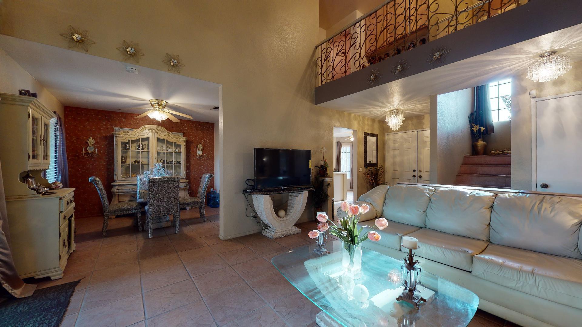 45808 Sutter Creek Road Indio, CA 92201 - Photo 14 of 55 a living room with furniture a flat screen tv and a dining table