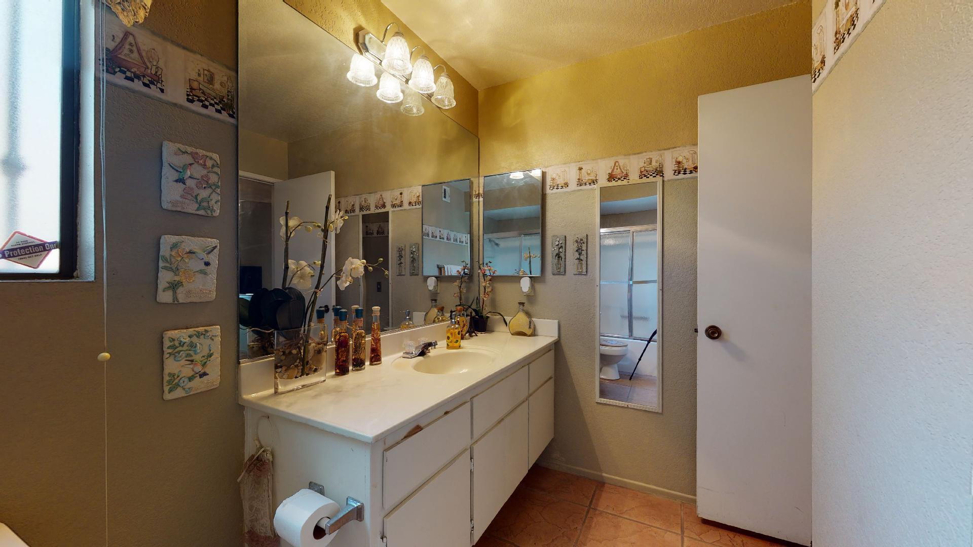 45808 Sutter Creek Road Indio, CA 92201 - Photo 19 of 55 a bathroom with a sink vanity and a mirror