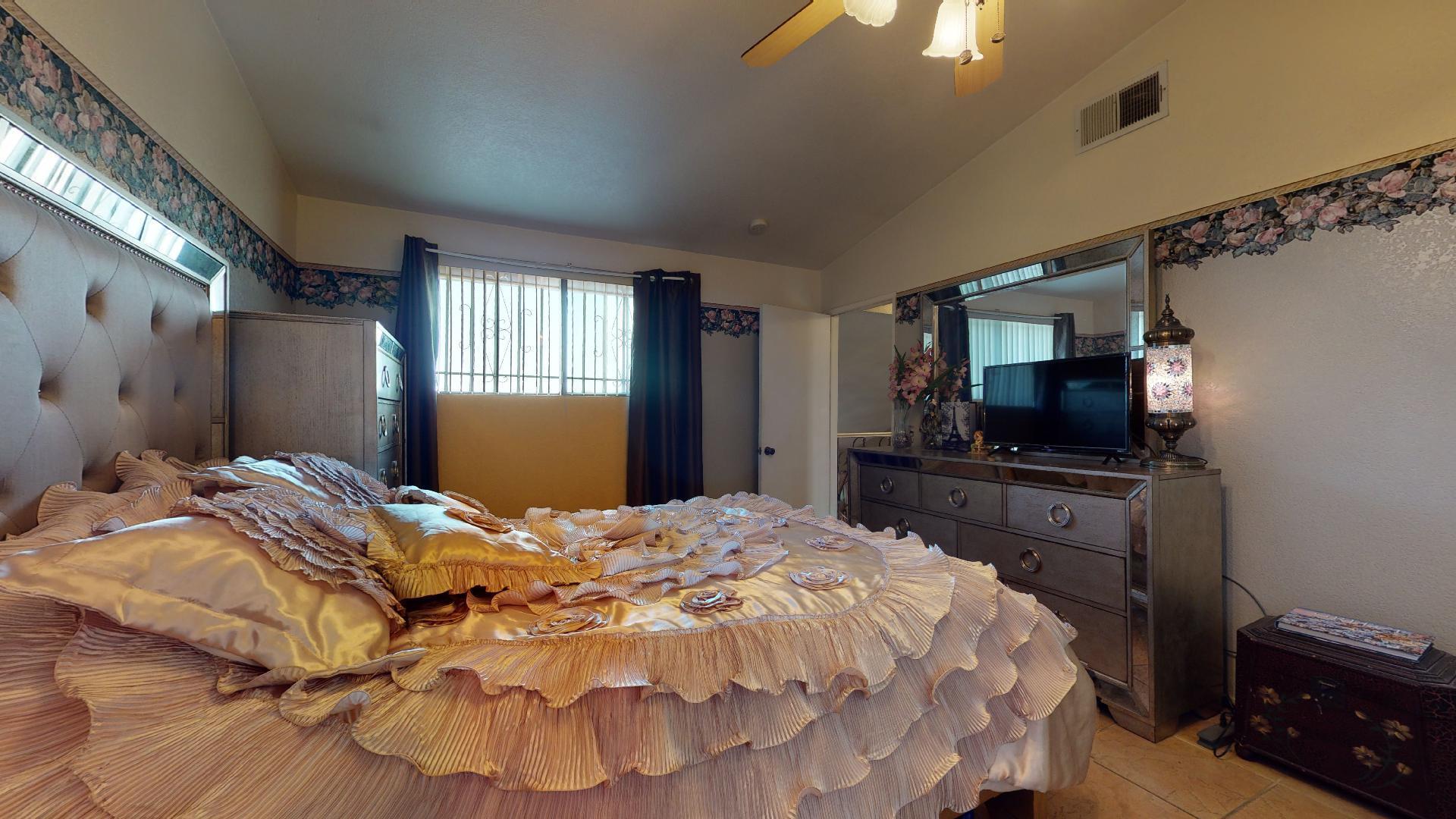 45808 Sutter Creek Road Indio, CA 92201 - Photo 24 of 55 a bedroom with a bed and a flat tv screen on dresser