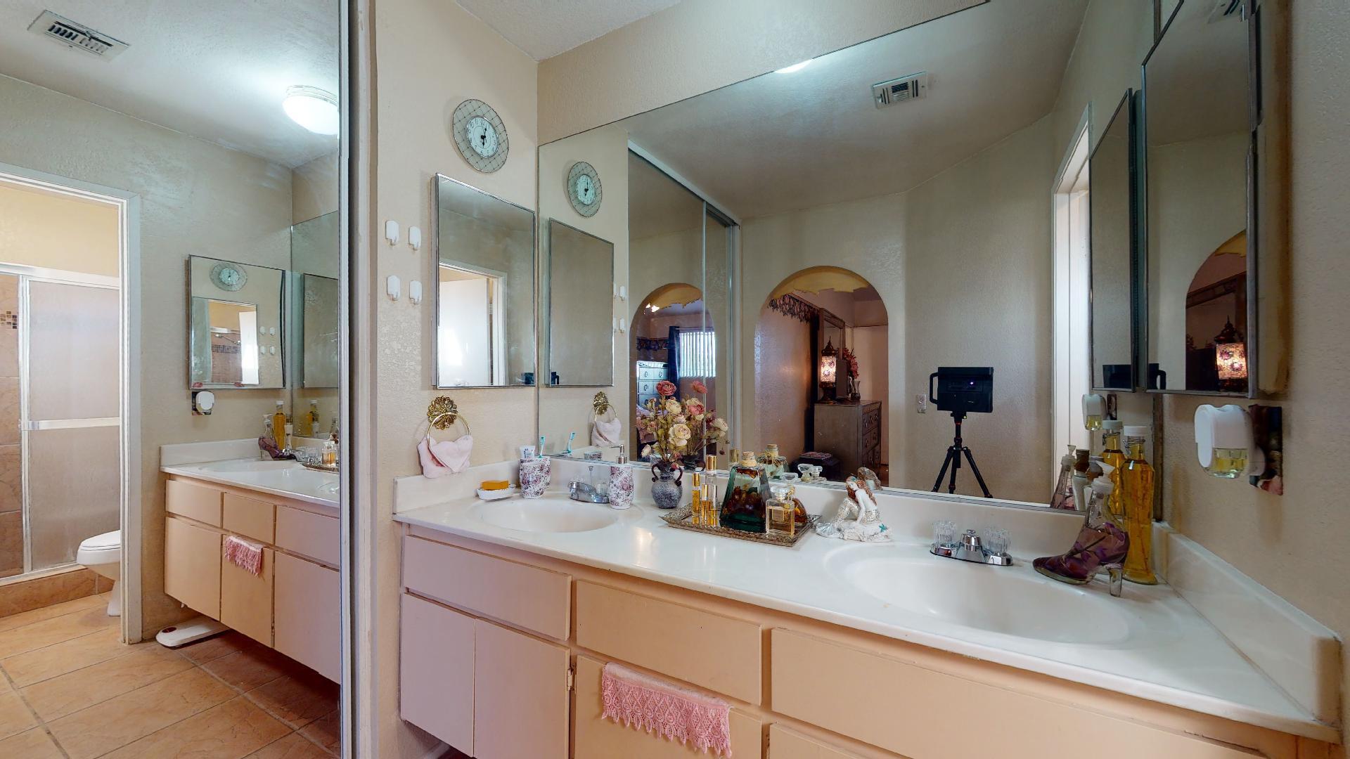 45808 Sutter Creek Road Indio, CA 92201 - Photo 26 of 55 a bathroom with a double vanity sink and a mirror