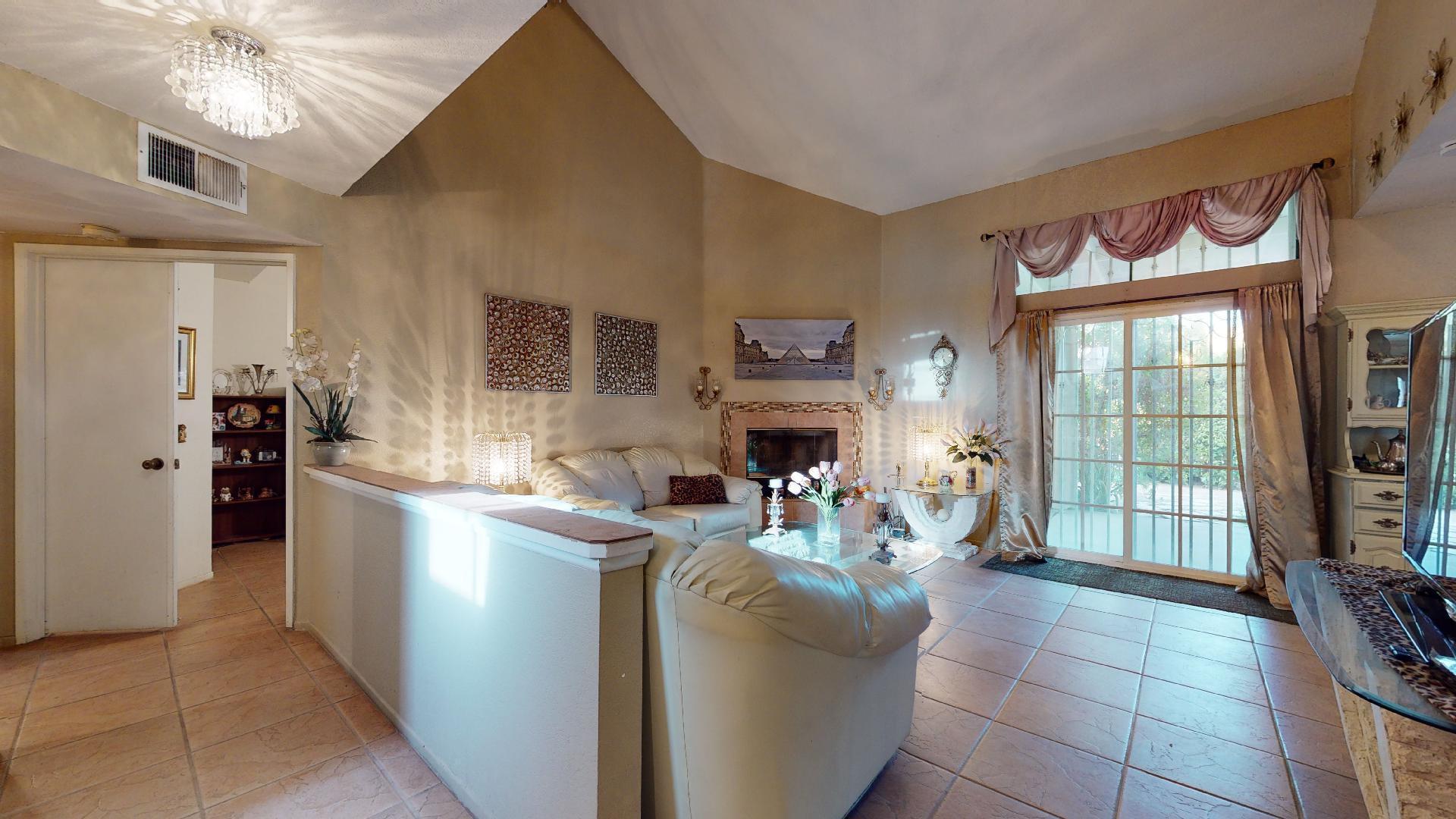 45808 Sutter Creek Road Indio, CA 92201 - Photo 4 of 55 a living room with furniture a window and a fireplace