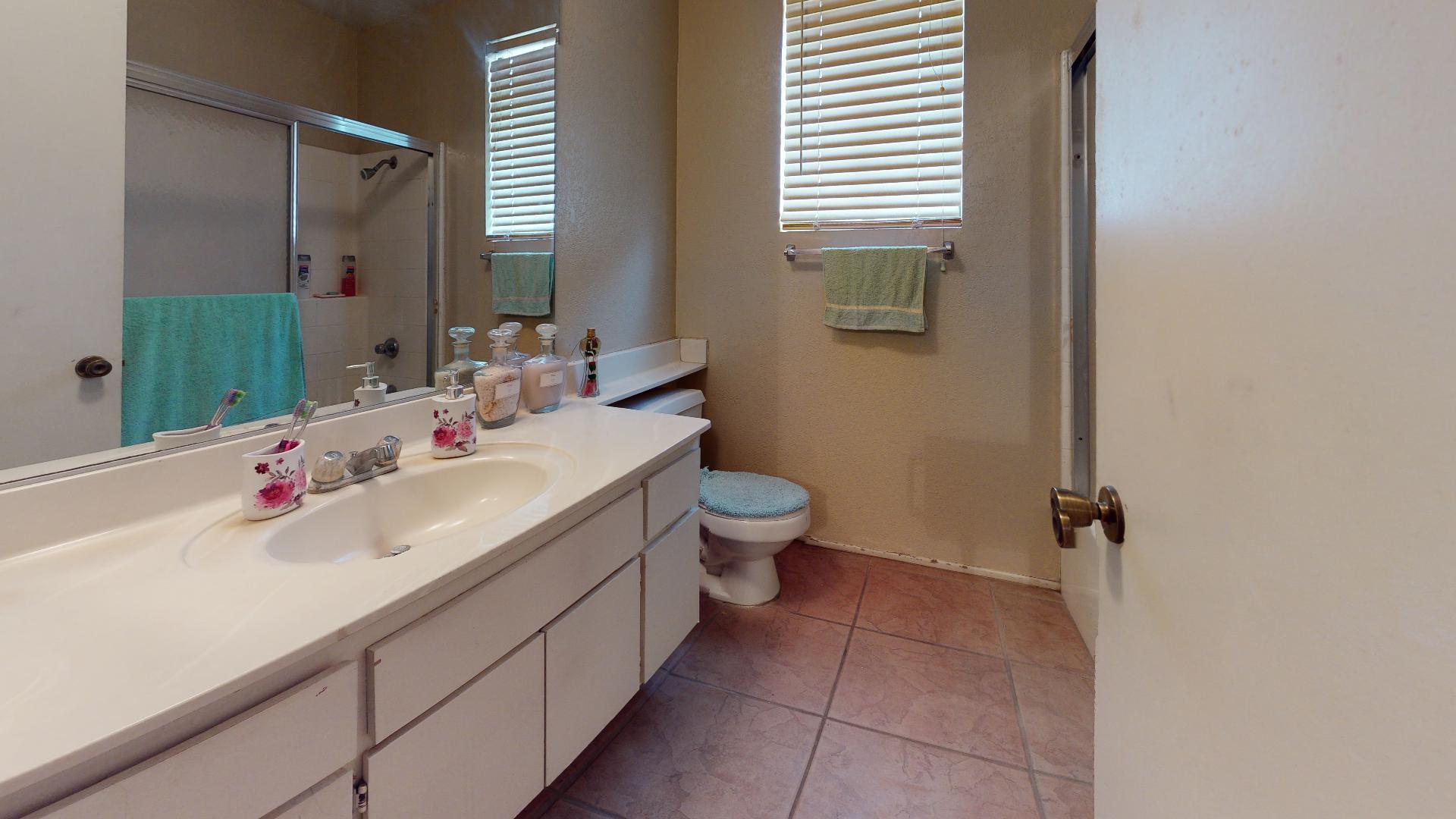 45808 Sutter Creek Road Indio, CA 92201 - Photo 36 of 55 a bathroom with a sink and mirror with toilet