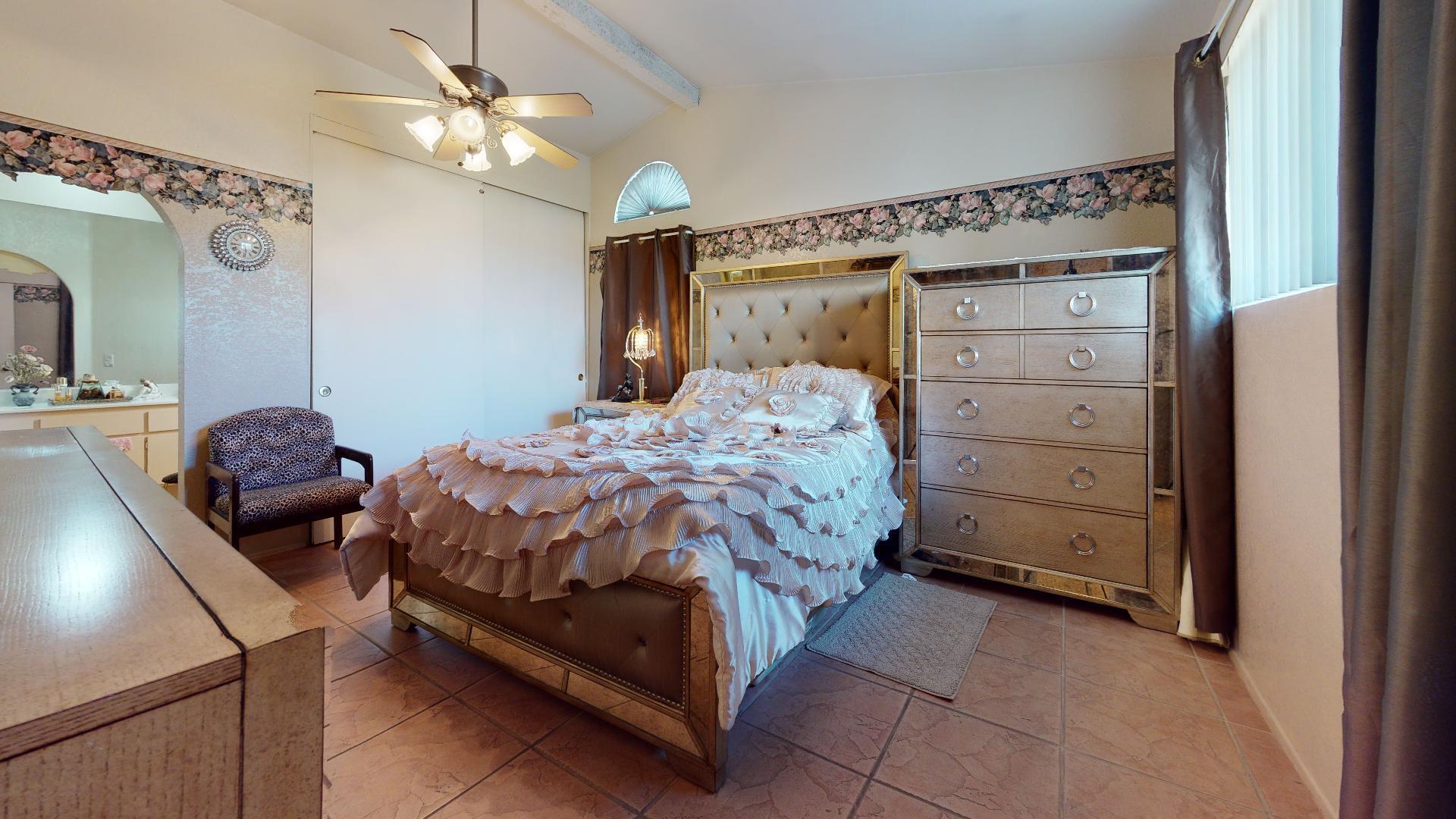 45808 Sutter Creek Road Indio, CA 92201 - Photo 42 of 55 a bedroom with a bed and a chandelier