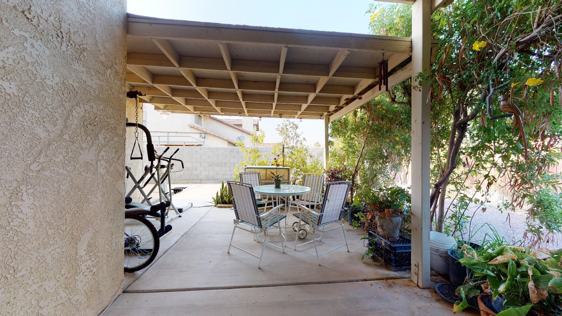 45808 Sutter Creek Road Indio, CA 92201 - Photo 54 of 55 a view of patio with table and chairs and potted plants