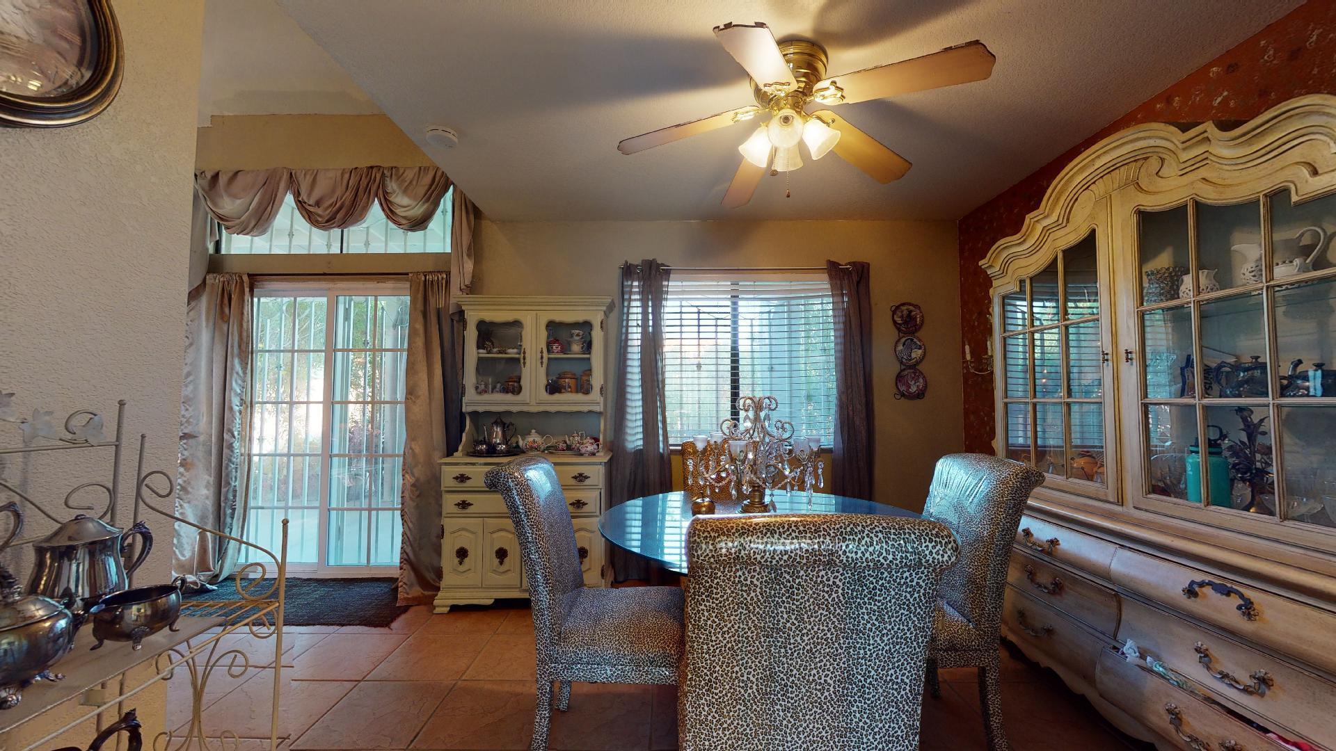 45808 Sutter Creek Road Indio, CA 92201 - Photo 9 of 55 a living room with furniture a chandelier and a floor to ceiling window