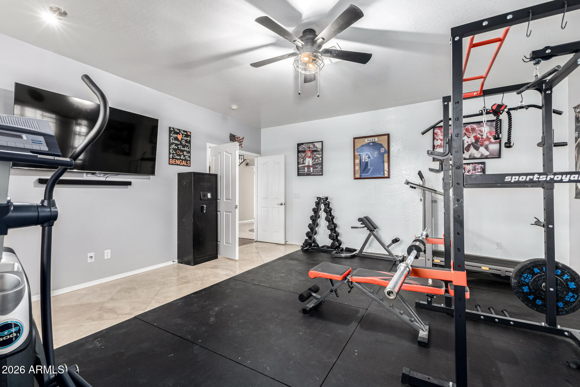 24541 Plum Road Florence, AZ 85132 - Photo 34 of 47 a room with gym equipment and a flat screen tv