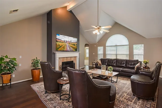 a living room with furniture a fireplace and a potted plant
