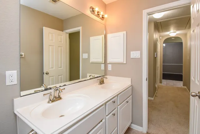 a bathroom with a sink vanity and mirror