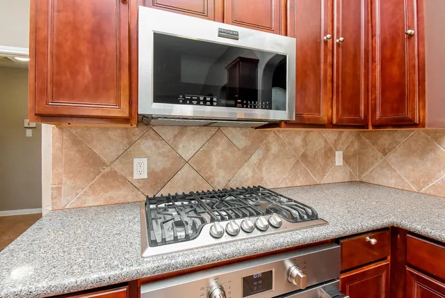 a view of a kitchen with a sink and cabinets