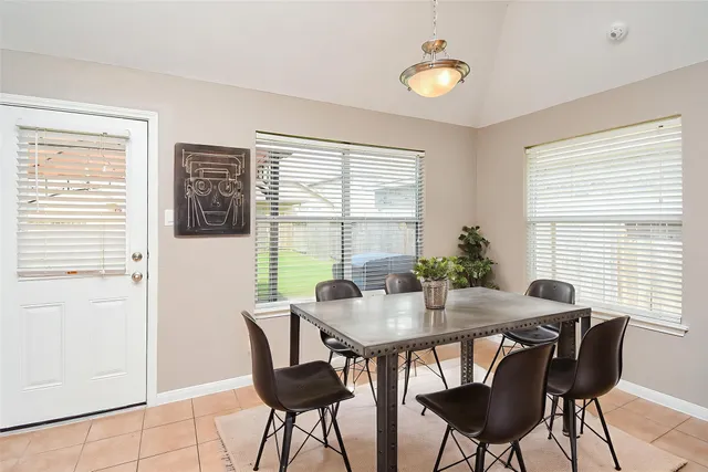 a view of a dining room with furniture and window