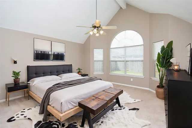 a bedroom with a bed and a window