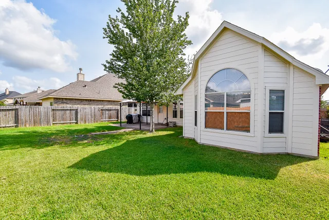 a front view of house with yard and green space