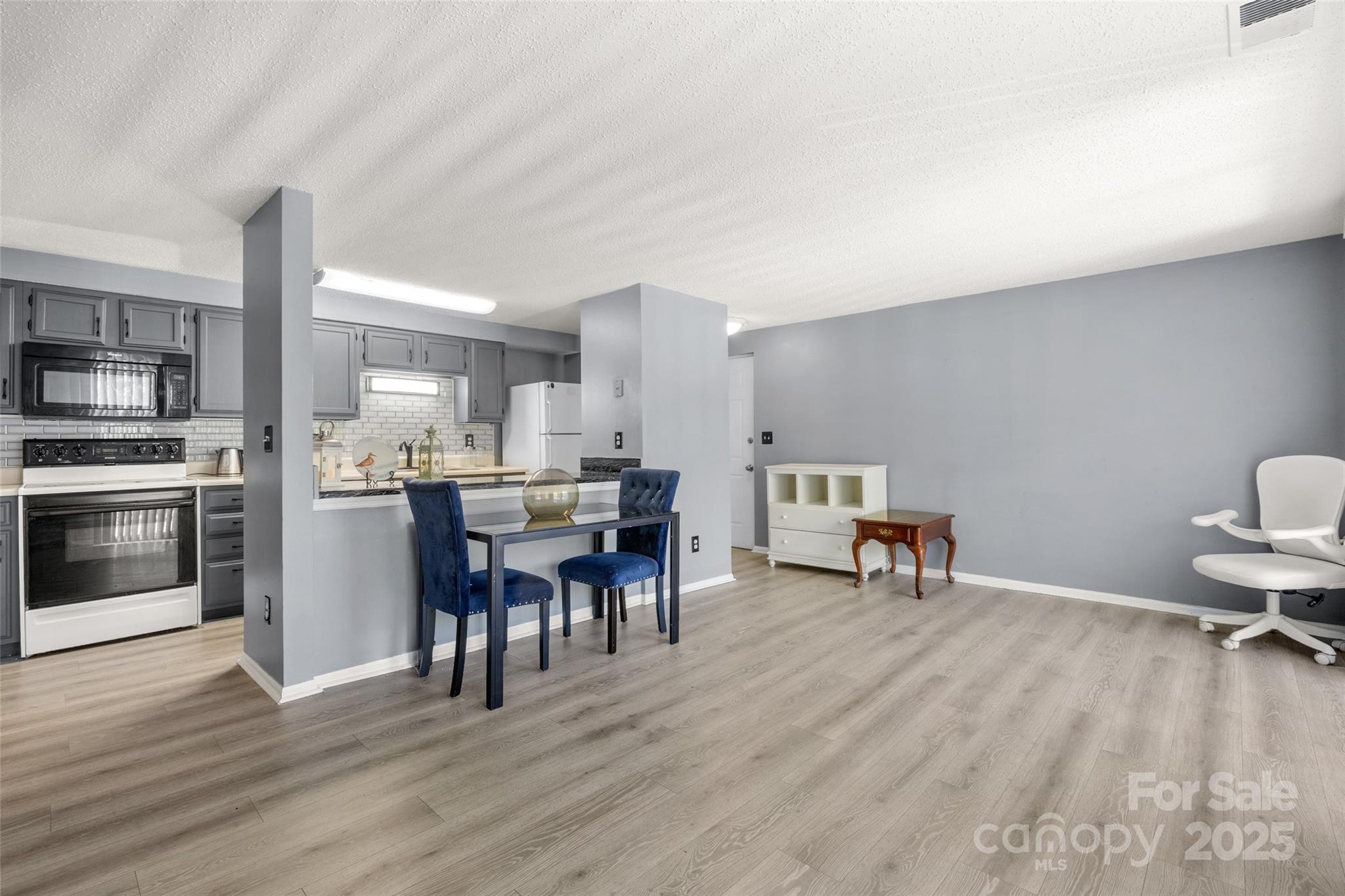 1634 Arlyn Circle, Unit J Charlotte, NC 28213 - Photo 3 of 13 a view of a dining room with furniture and wooden floor