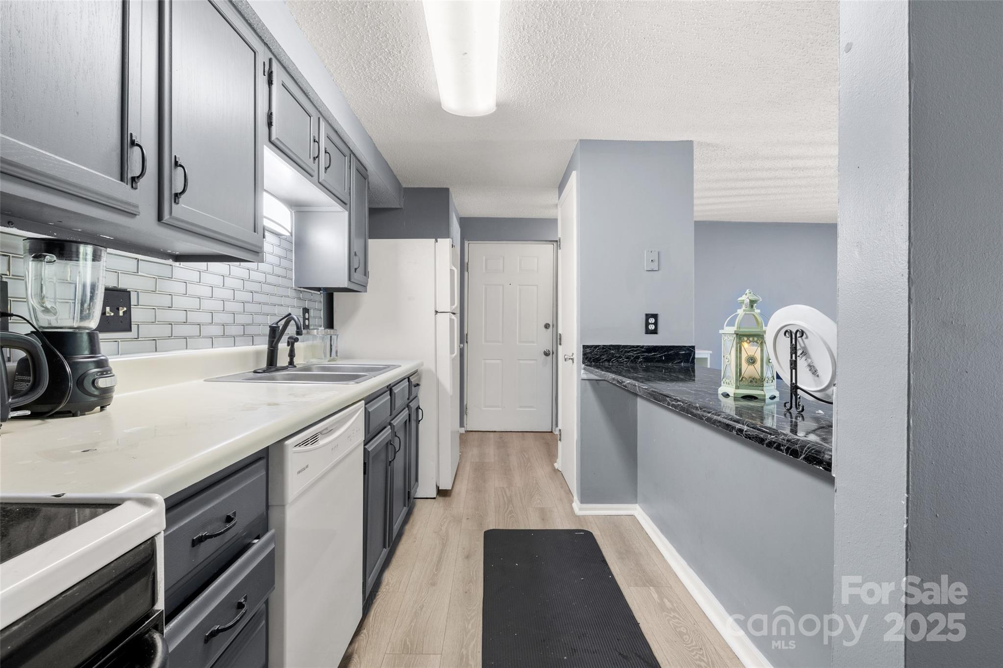 1634 Arlyn Circle, Unit J Charlotte, NC 28213 - Photo 5 of 13 a kitchen with a sink and cabinets