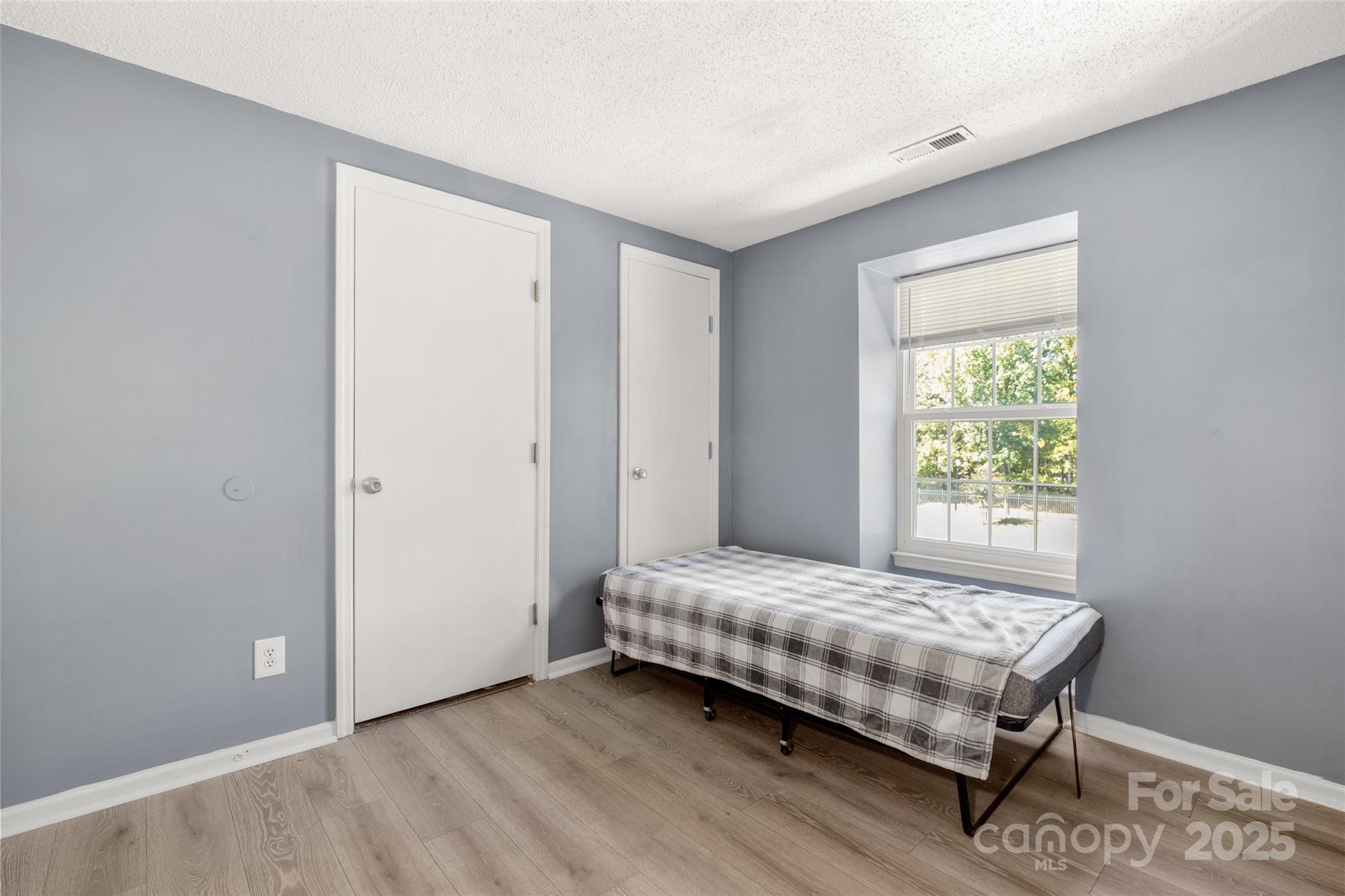 1634 Arlyn Circle, Unit J Charlotte, NC 28213 - Photo 8 of 13 a room with a bed and a window