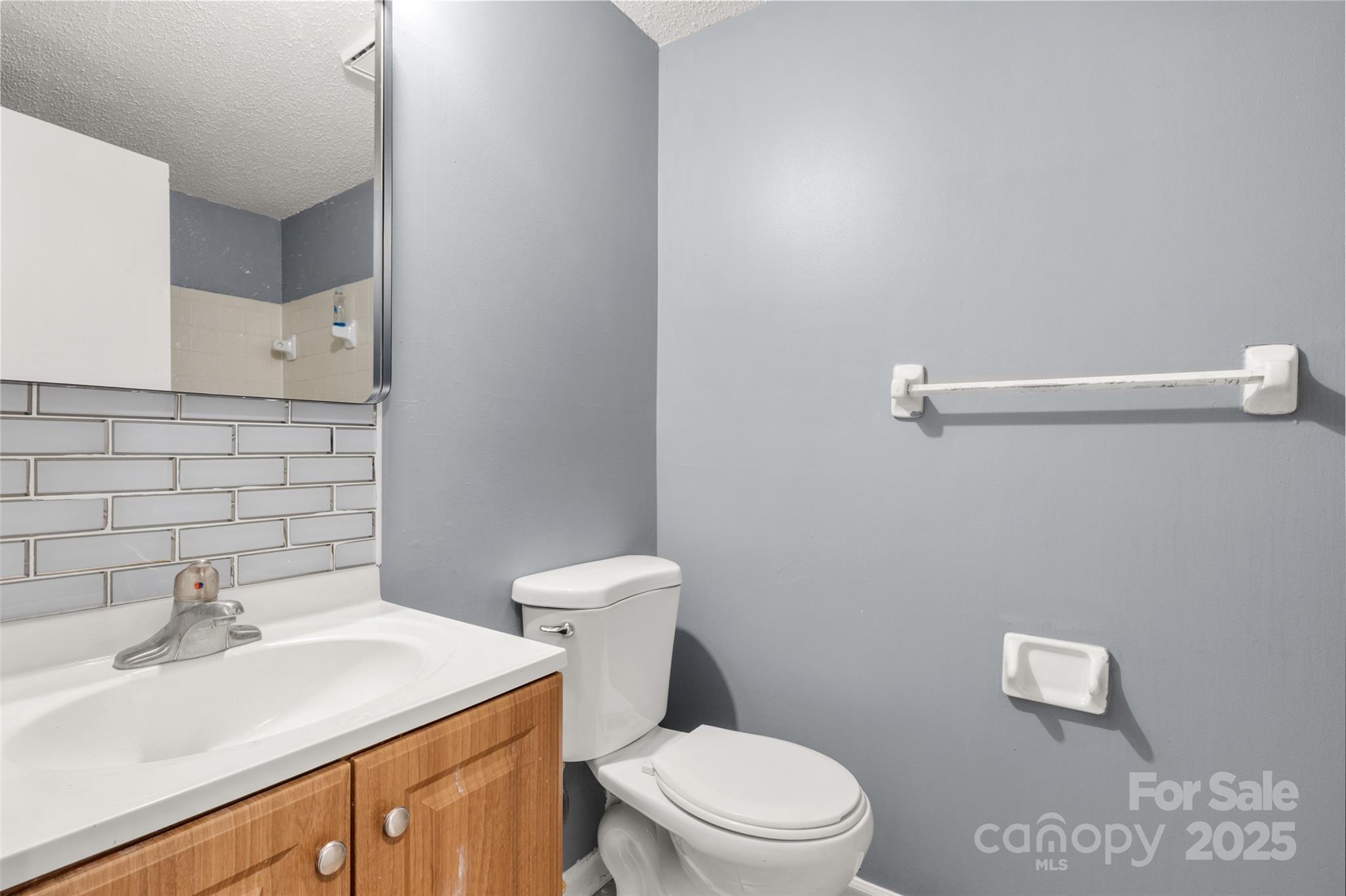 1634 Arlyn Circle, Unit J Charlotte, NC 28213 - Photo 9 of 13 a bathroom with a sink a toilet and mirror