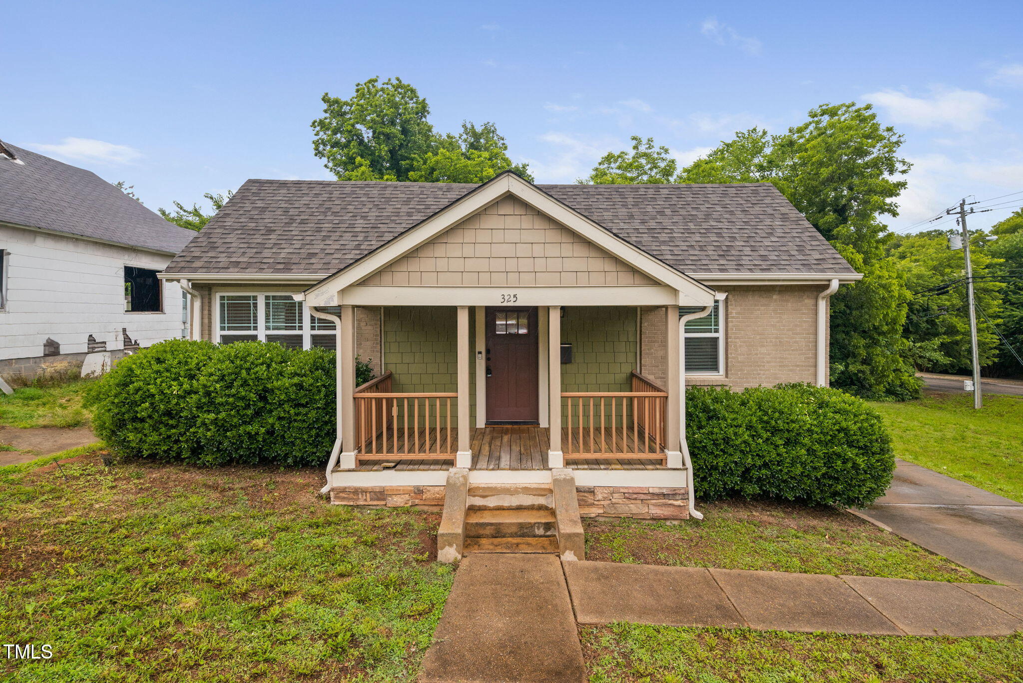 a front view of a house with a garden