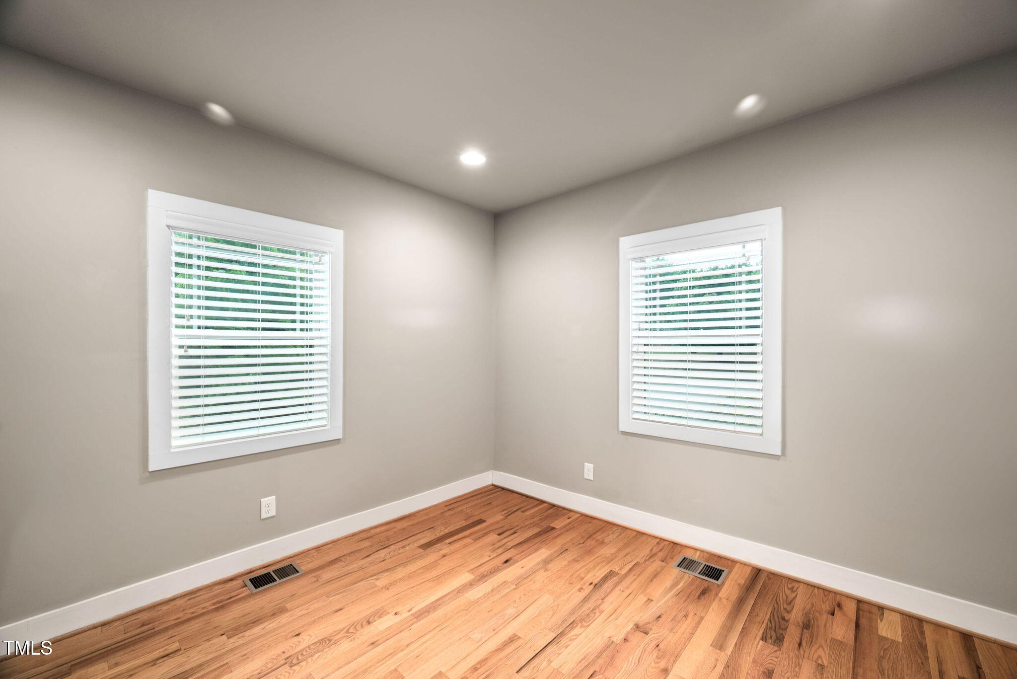 325 Martin Luther King Jr Boulevard Raleigh, NC 27601 - Photo 11 of 32 a view of an empty room with wooden floor and a window