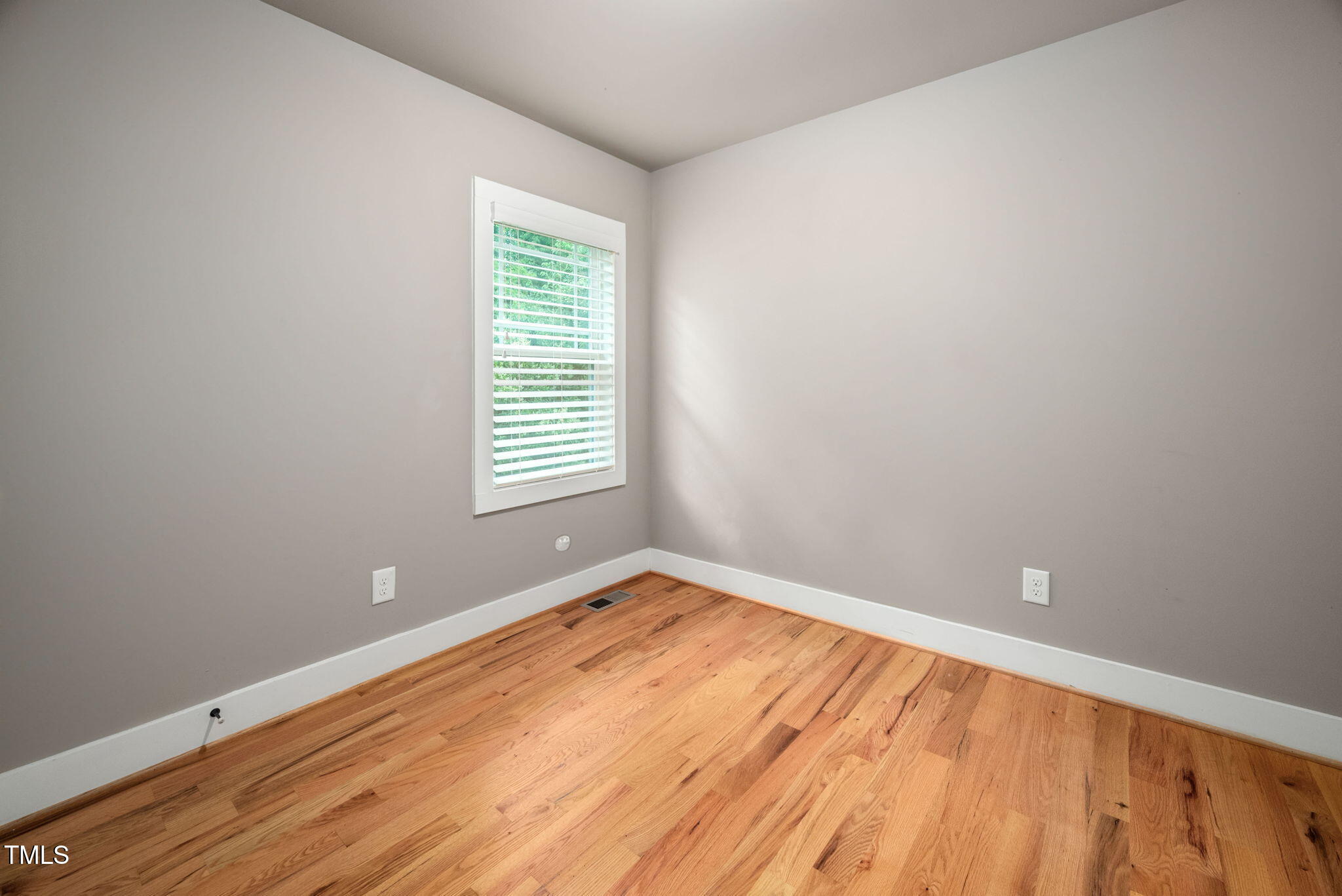 325 Martin Luther King Jr Boulevard Raleigh, NC 27601 - Photo 18 of 32 wooden floor in an empty room with a window