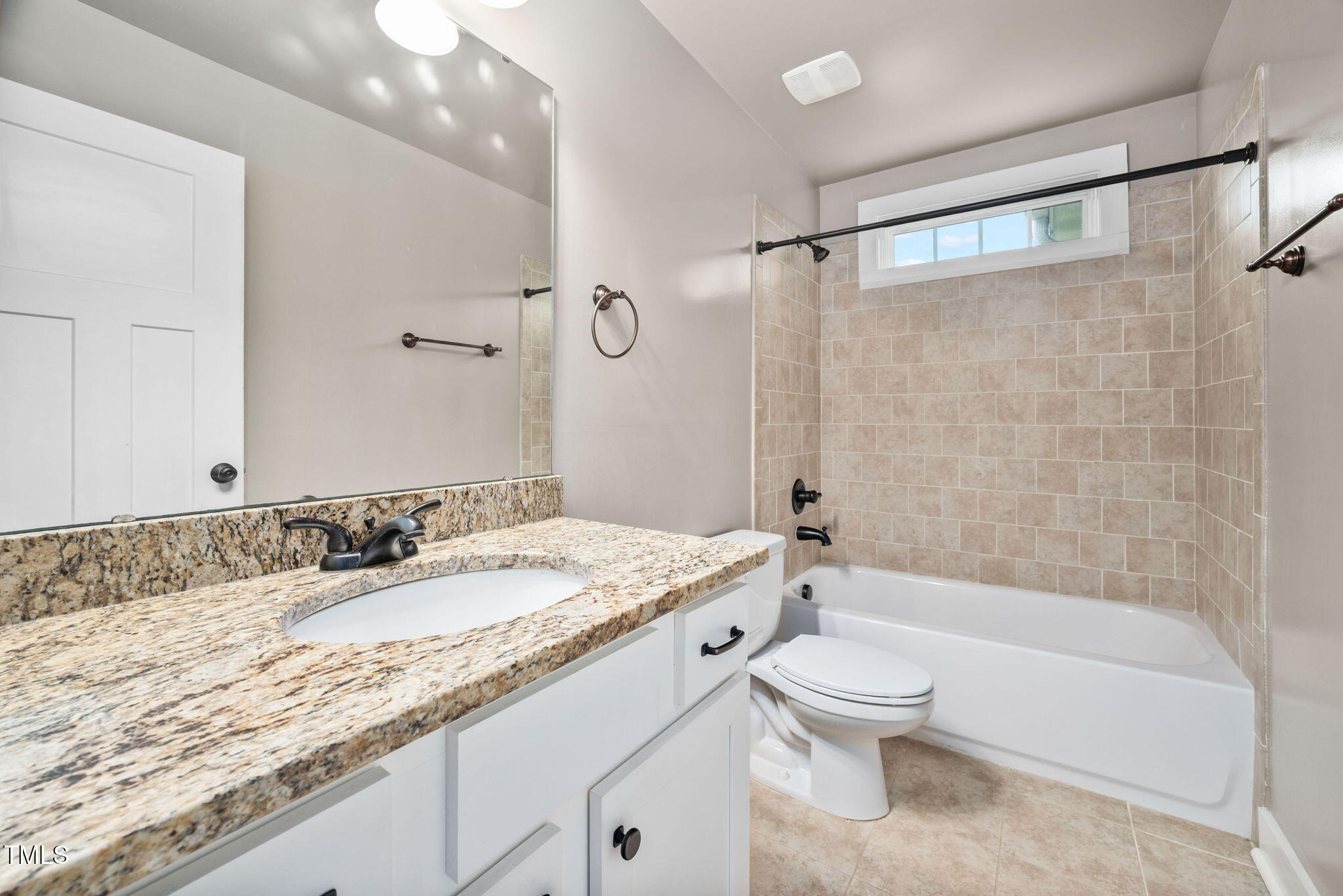 325 Martin Luther King Jr Boulevard Raleigh, NC 27601 - Photo 20 of 32 a bathroom with a granite countertop sink a toilet and shower