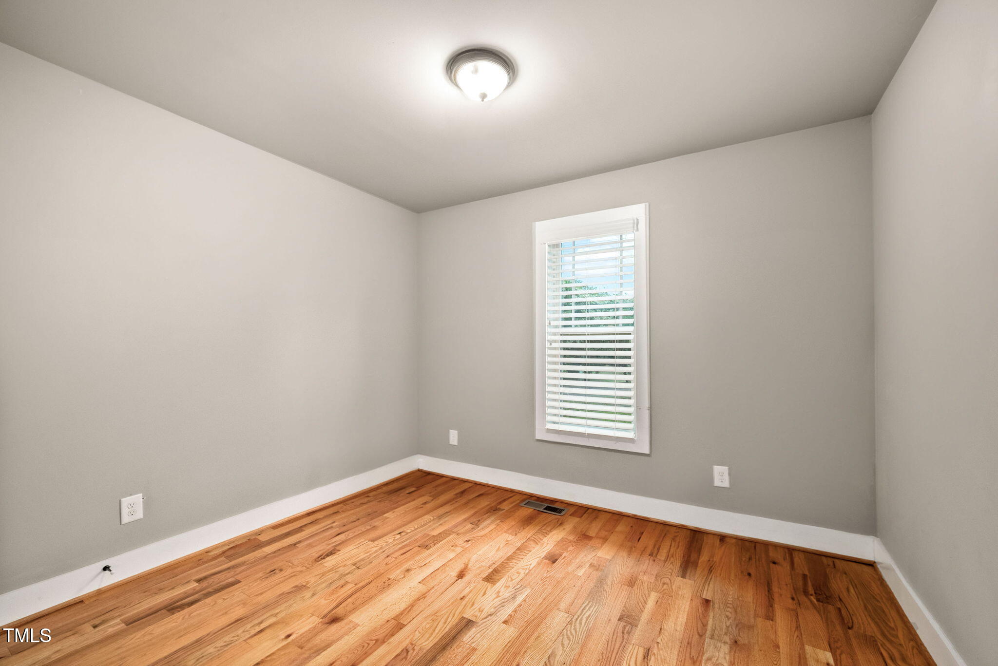 325 Martin Luther King Jr Boulevard Raleigh, NC 27601 - Photo 21 of 32 an empty room with a hardwood and a window