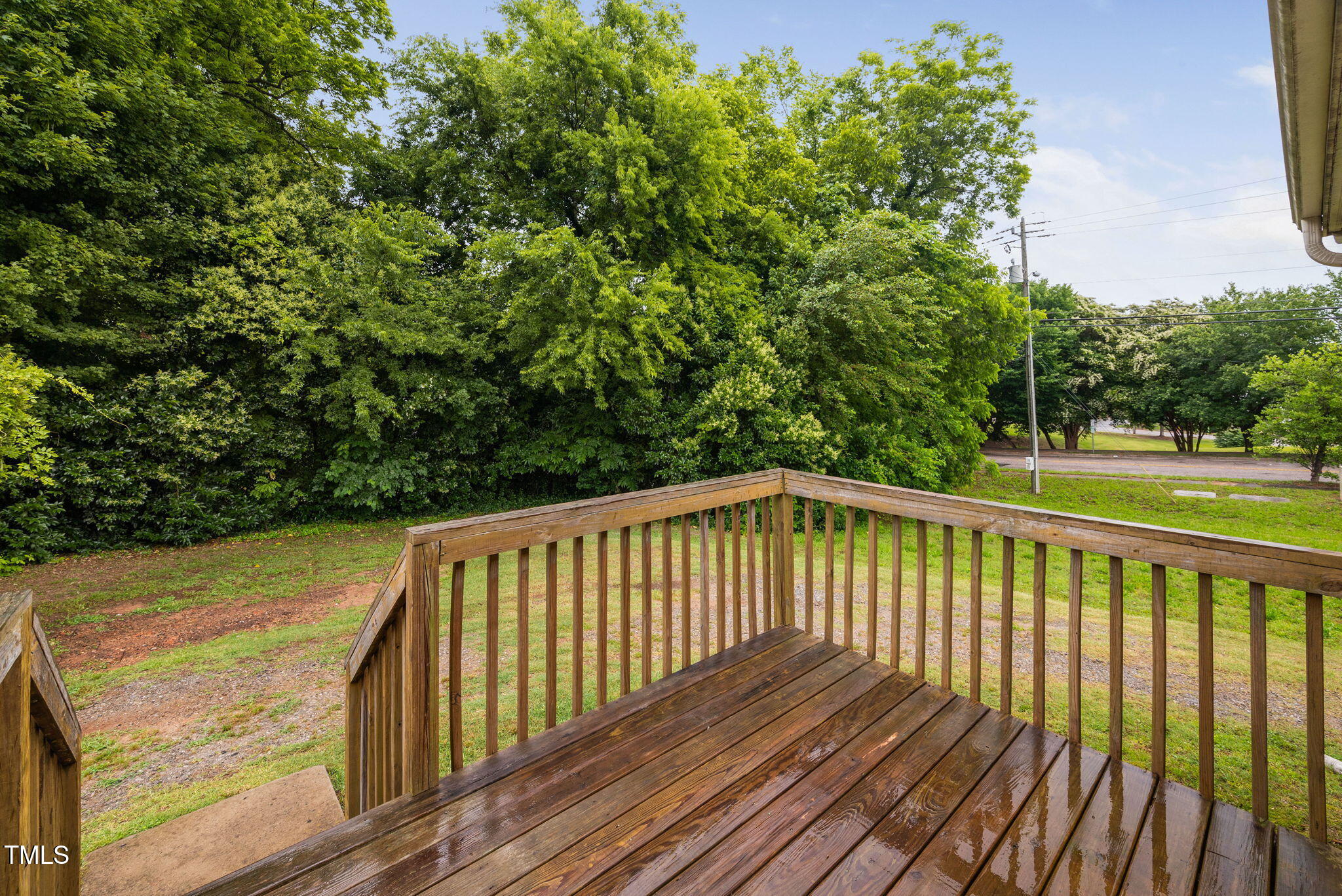 325 Martin Luther King Jr Boulevard Raleigh, NC 27601 - Photo 24 of 32 a balcony with wooden floor and yard in the back