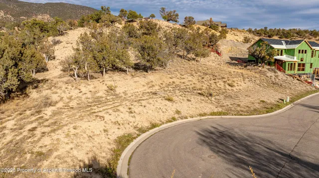 a view of multiple houses with a street
