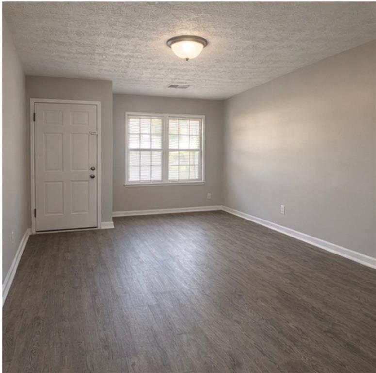 846 Wilson Circle Southwest Marietta, GA 30064 - Photo 2 of 6 an empty room with wooden floor and windows
