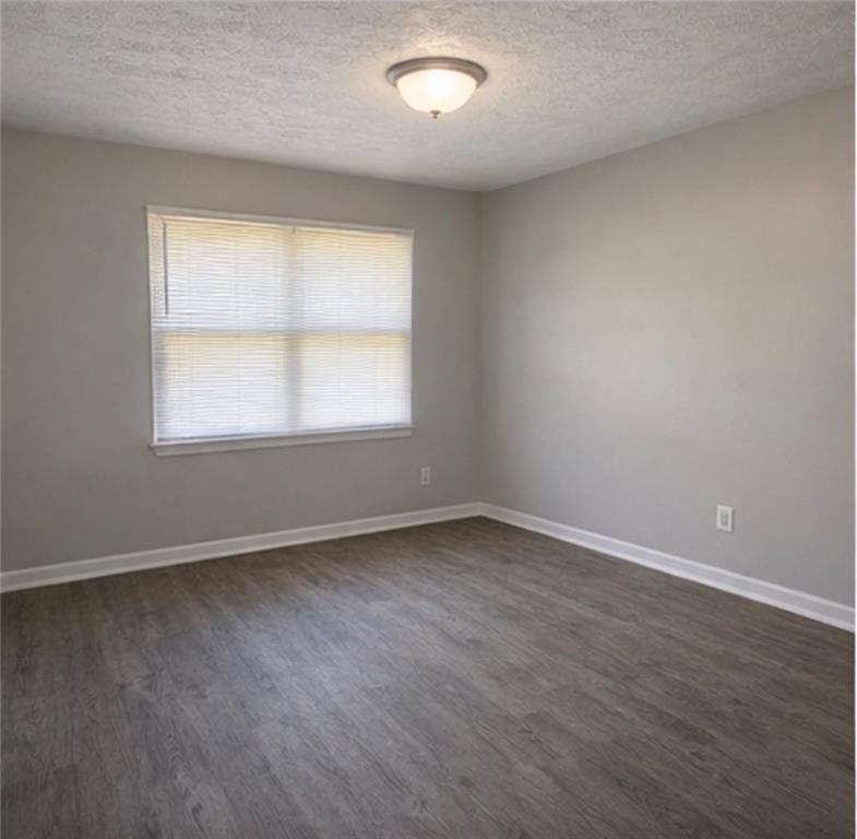 846 Wilson Circle Southwest Marietta, GA 30064 - Photo 5 of 6 an empty room with wooden floor and windows
