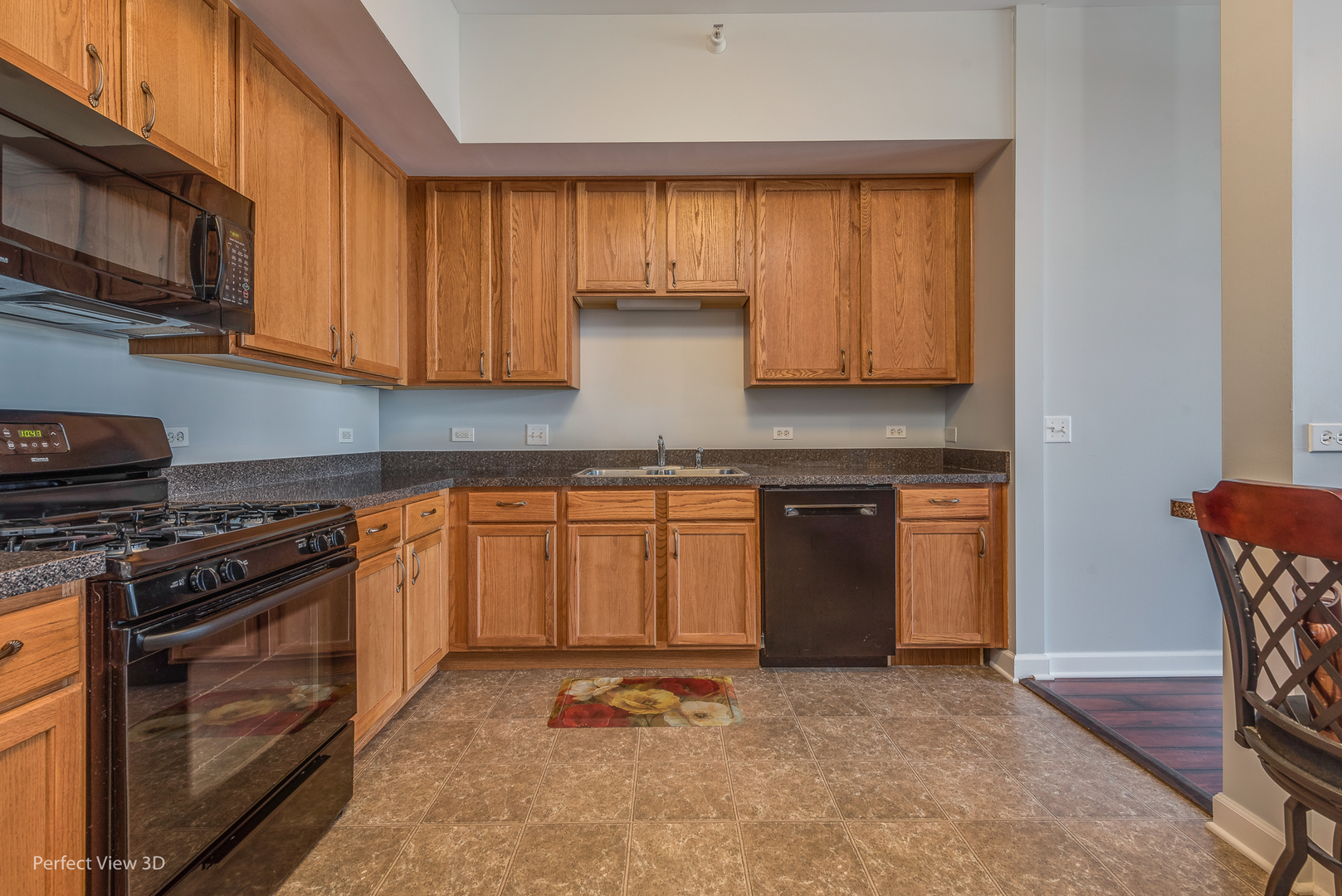 77 North Wolf Road, Unit 601 Northlake, IL 60164 - Photo 5 of 19 a kitchen with granite countertop a stove top oven microwave and cabinets