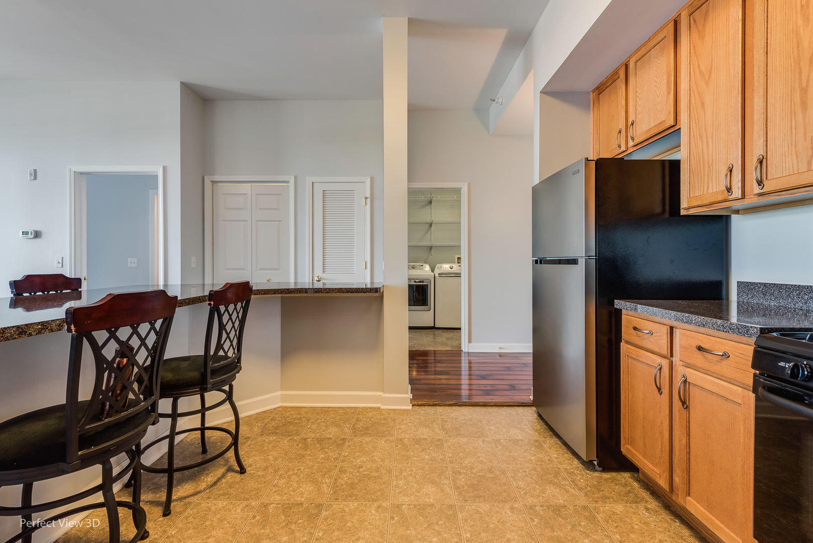 77 North Wolf Road, Unit 601 Northlake, IL 60164 - Photo 6 of 19 a view of a kitchen with furniture and a refrigerator
