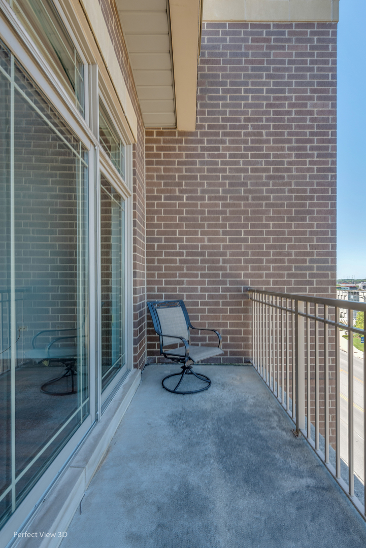 77 North Wolf Road, Unit 601 Northlake, IL 60164 - Photo 9 of 19 a view of a brick wall with a chair