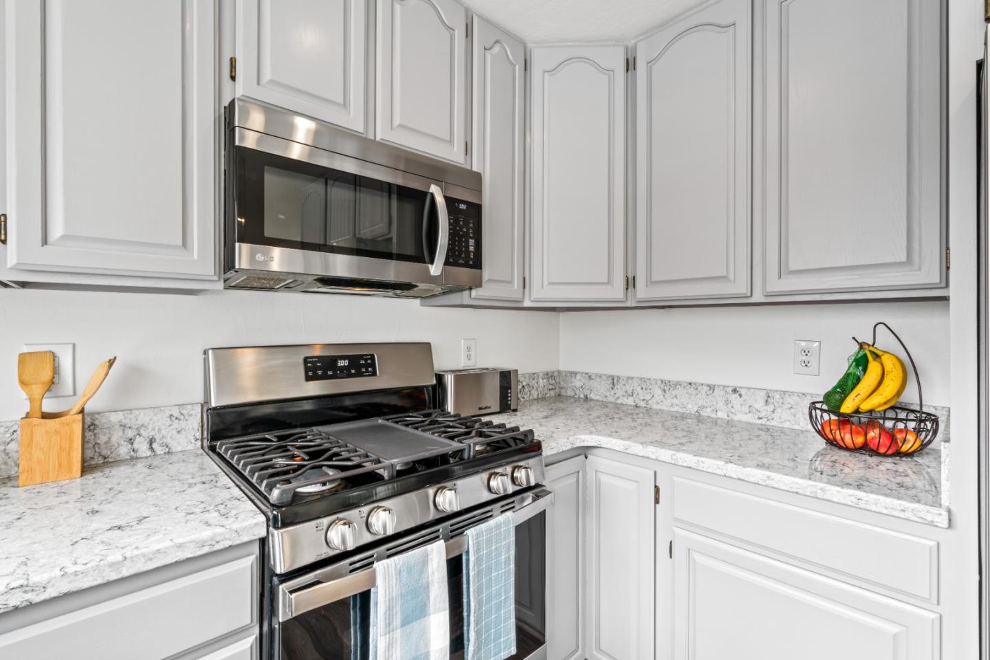 804 Prairie Creek Drive Pacifica, CA 94044 - Photo 11 of 64 a kitchen with stainless steel appliances granite countertop a stove a microwave a sink and cabinets