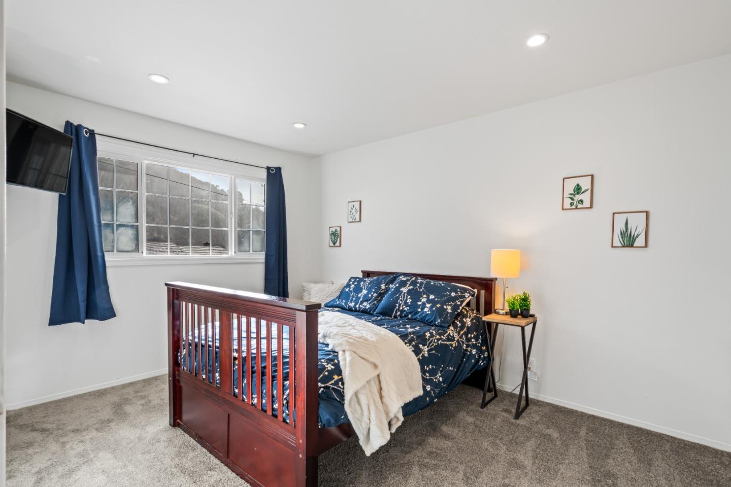 804 Prairie Creek Drive Pacifica, CA 94044 - Photo 16 of 64 a bed sitting in a bedroom next to a window