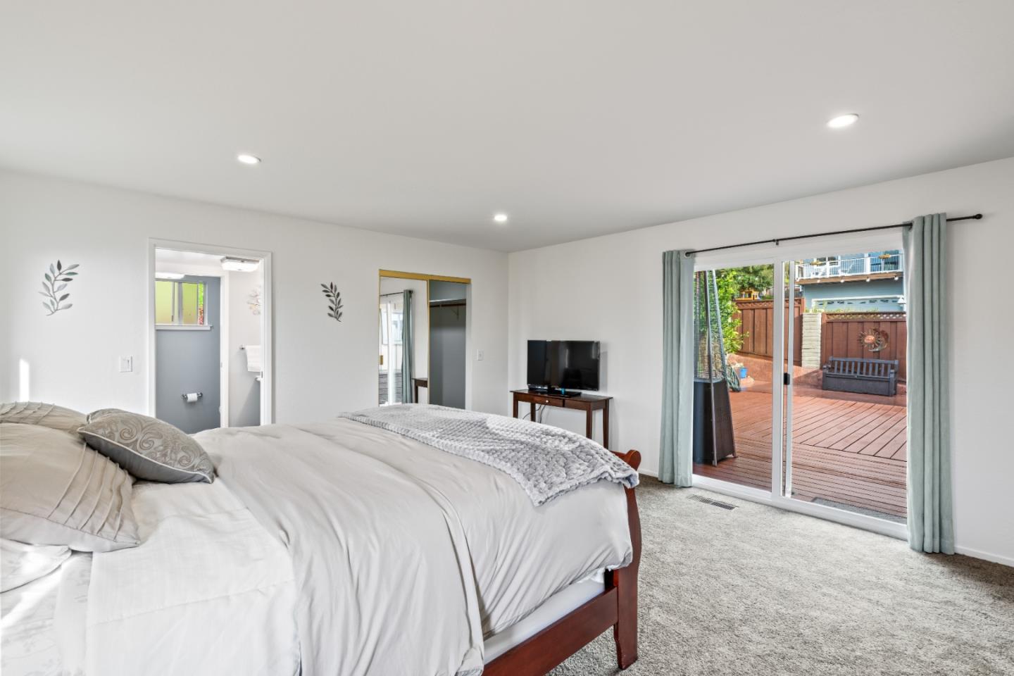 804 Prairie Creek Drive Pacifica, CA 94044 - Photo 21 of 64 a bedroom with a bed and a flat screen tv