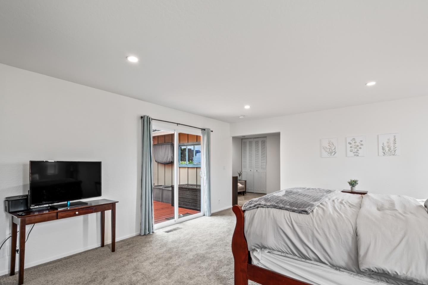 804 Prairie Creek Drive Pacifica, CA 94044 - Photo 22 of 64 a bedroom with a bed and a flat screen tv