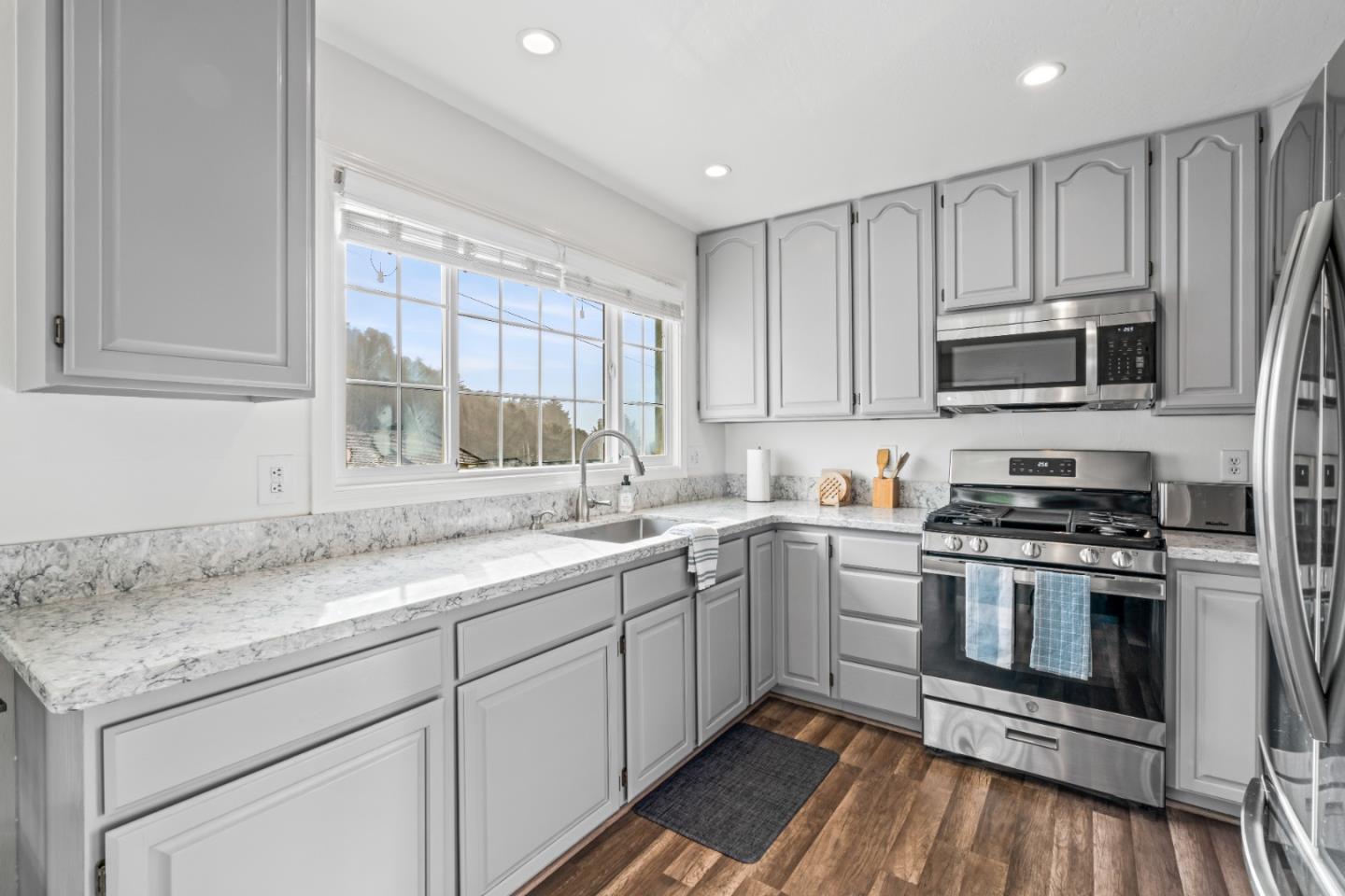 804 Prairie Creek Drive Pacifica, CA 94044 - Photo 10 of 64 a kitchen with granite countertop a sink stainless steel appliances and cabinets