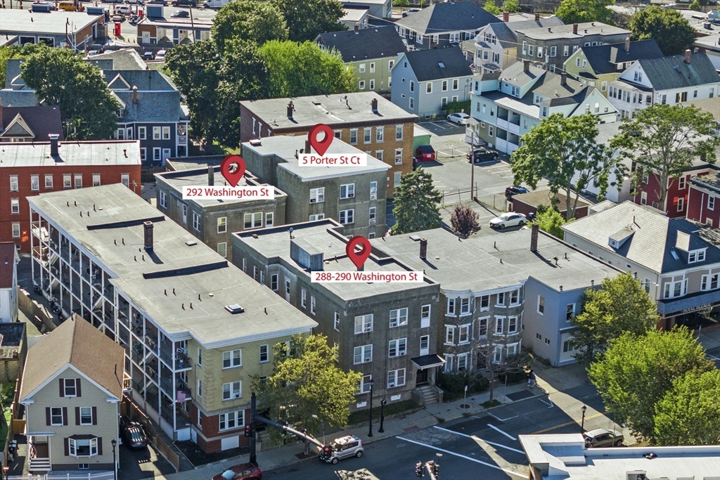 a aerial view of multi story residential apartment building with yard