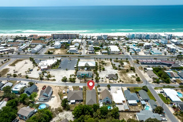 a large kitchen with granite countertop a stove top oven a sink a counter space and cabinets