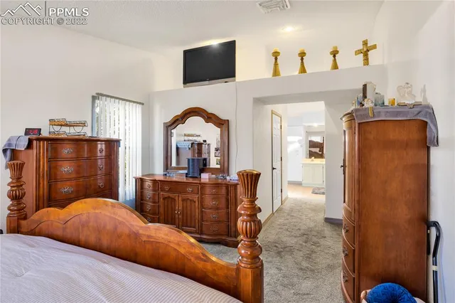 a bedroom with a bed and a dresser