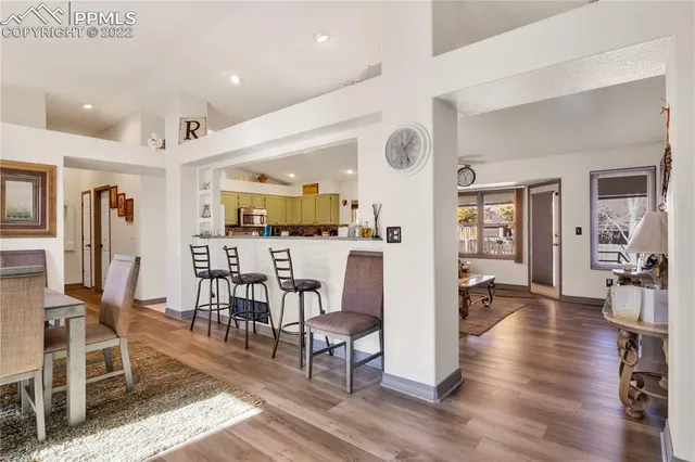 a view of a dining room with furniture and wooden floor
