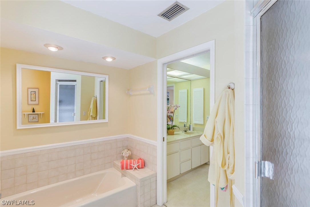 1341 Sand Castle Road Sanibel, FL 33957 - Photo 14 of 18 a bathroom with a bathtub and a shower