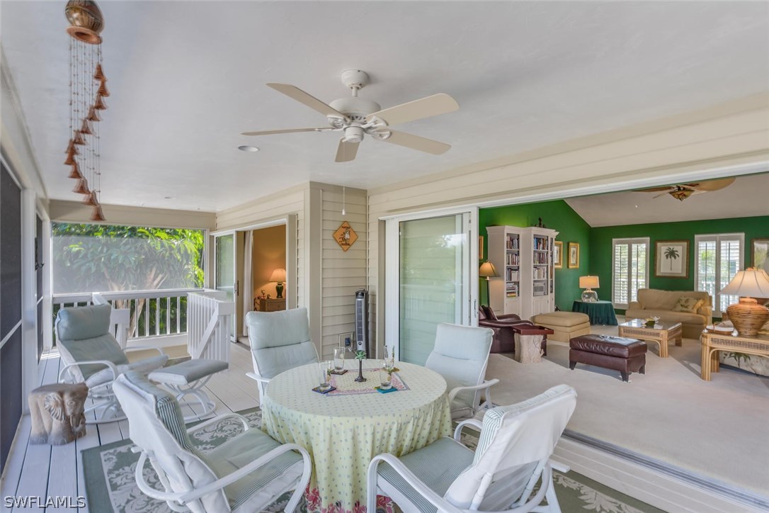 1341 Sand Castle Road Sanibel, FL 33957 - Photo 16 of 18 a living room with furniture a large window and a table
