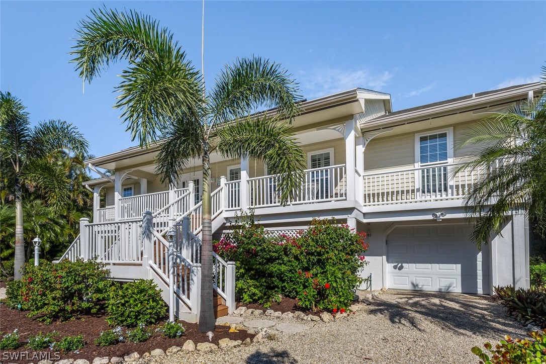 1341 Sand Castle Road Sanibel, FL 33957 - Photo 3 of 18 a front view of a house with garden