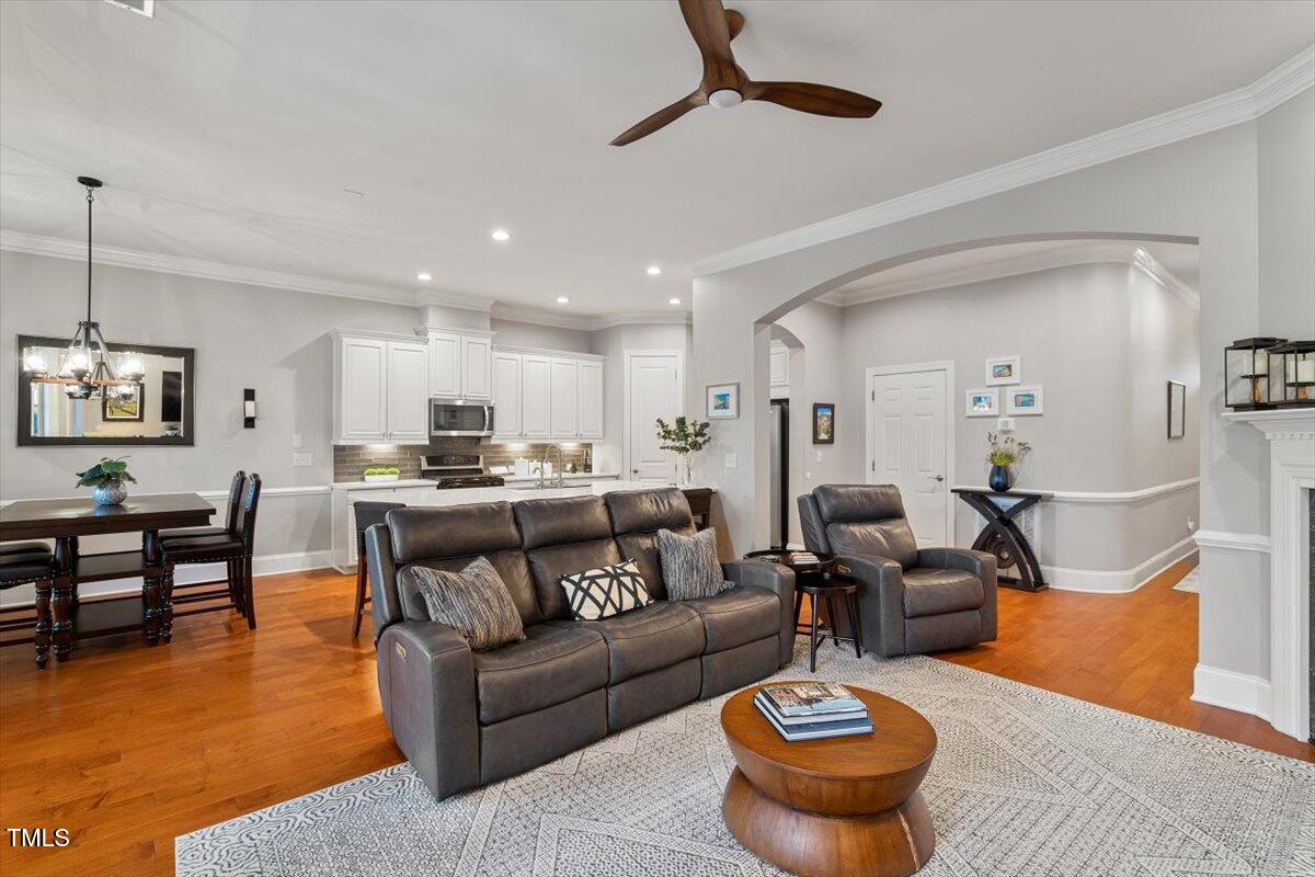105 Sunstone Drive Cary, NC 27519 - Photo 11 of 25 a living room with furniture and a dining table with wooden floor