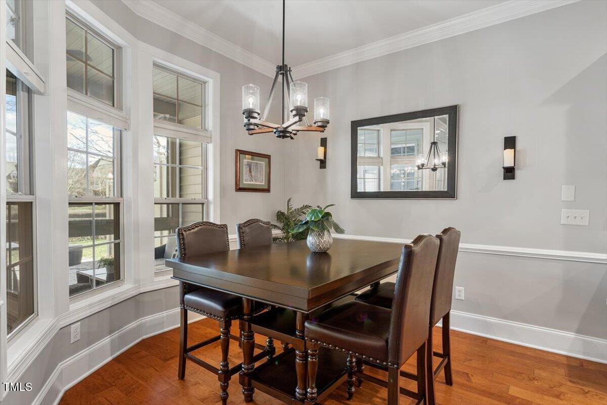 105 Sunstone Drive Cary, NC 27519 - Photo 12 of 25 a view of a dining room with furniture window and wooden floor