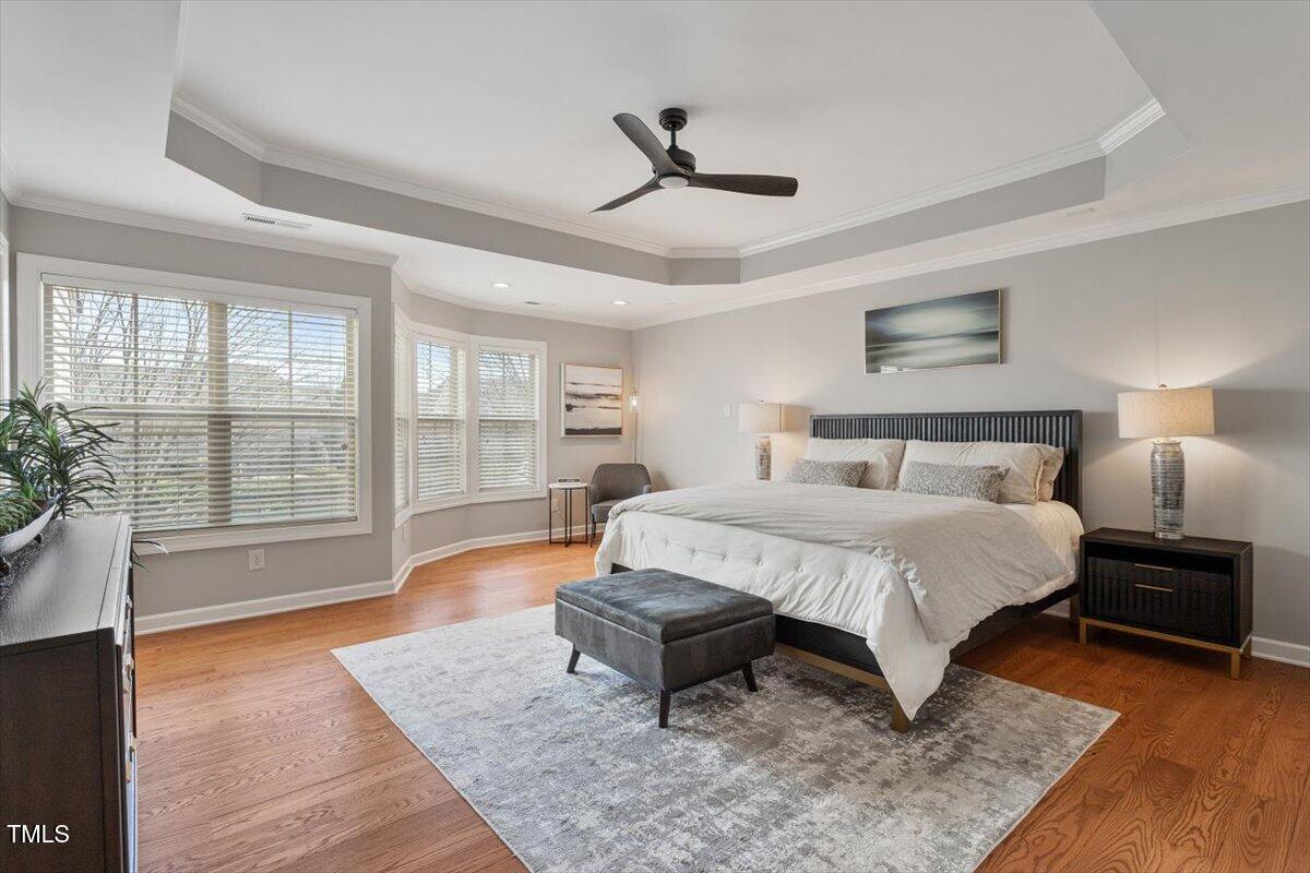 105 Sunstone Drive Cary, NC 27519 - Photo 15 of 25 a spacious bedroom with a bed and wooden floor